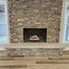 Stack stone with decorative concrete hearth