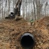Compacting the ground around newly installed culvert