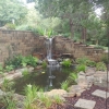 Retaining wall with waterfall into  Pond