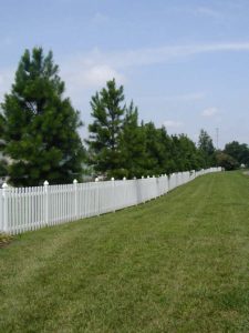 white vinyl fencing installed at the entrance of a subdivision that we built
