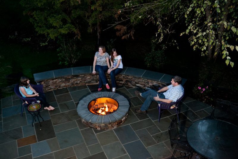 Premium Stone Patio Design & Build | High-End Backyard Hardscaping Solutions | Fire pit and seating area