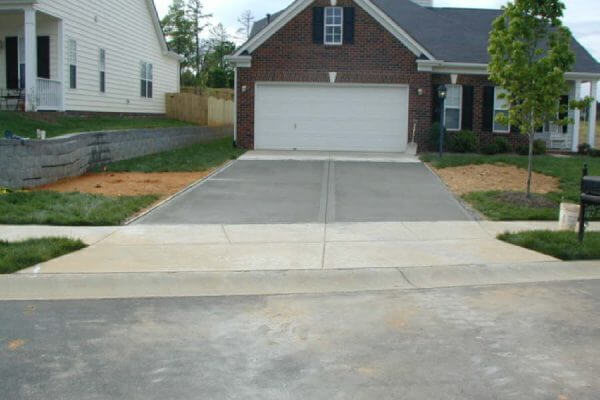 driveway and yard after remediated sinkhole, repaired driveway and retaining wall