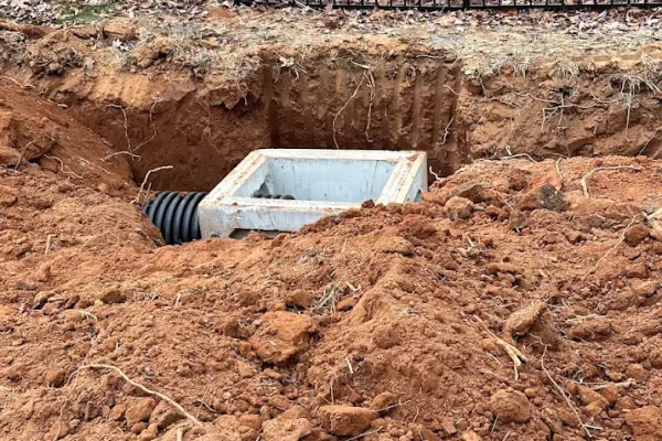 During the investigation, Bill Botkin discovered improperly graded swales that prevented water from flowing away from the home.