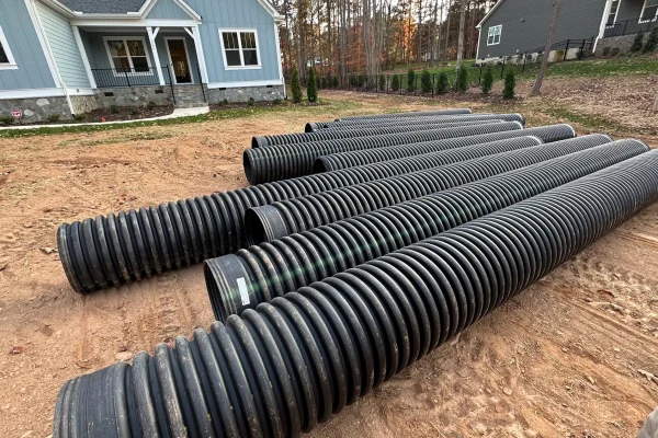 Extensive excavation revealed that previous drainage work had been completed without proper engineering calculations or grade verification.