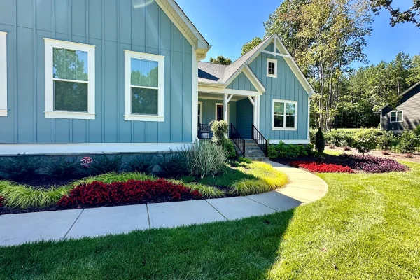 Once the drainage challenges were resolved, Outdoor Contracting transformed the property with custom landscaping, irrigation, and outdoor lighting.