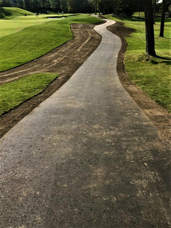 newly installed asphalt golf cart path through landscaped course